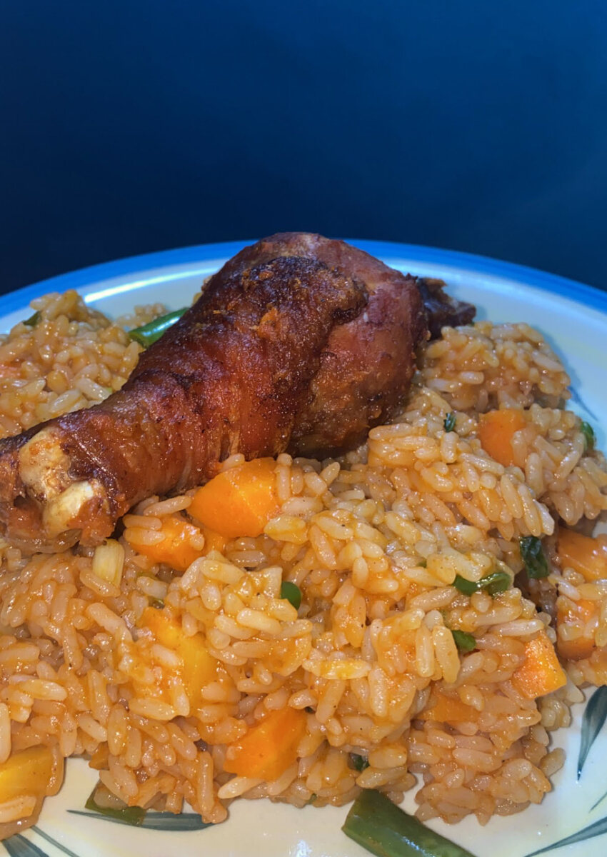 Nigerian jollof rice served with chicken