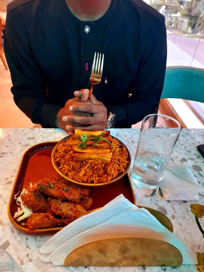 Jollof rice served with plantain and chicken